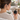 Woman relaxing at home holding the Biothm VNTune EZ device